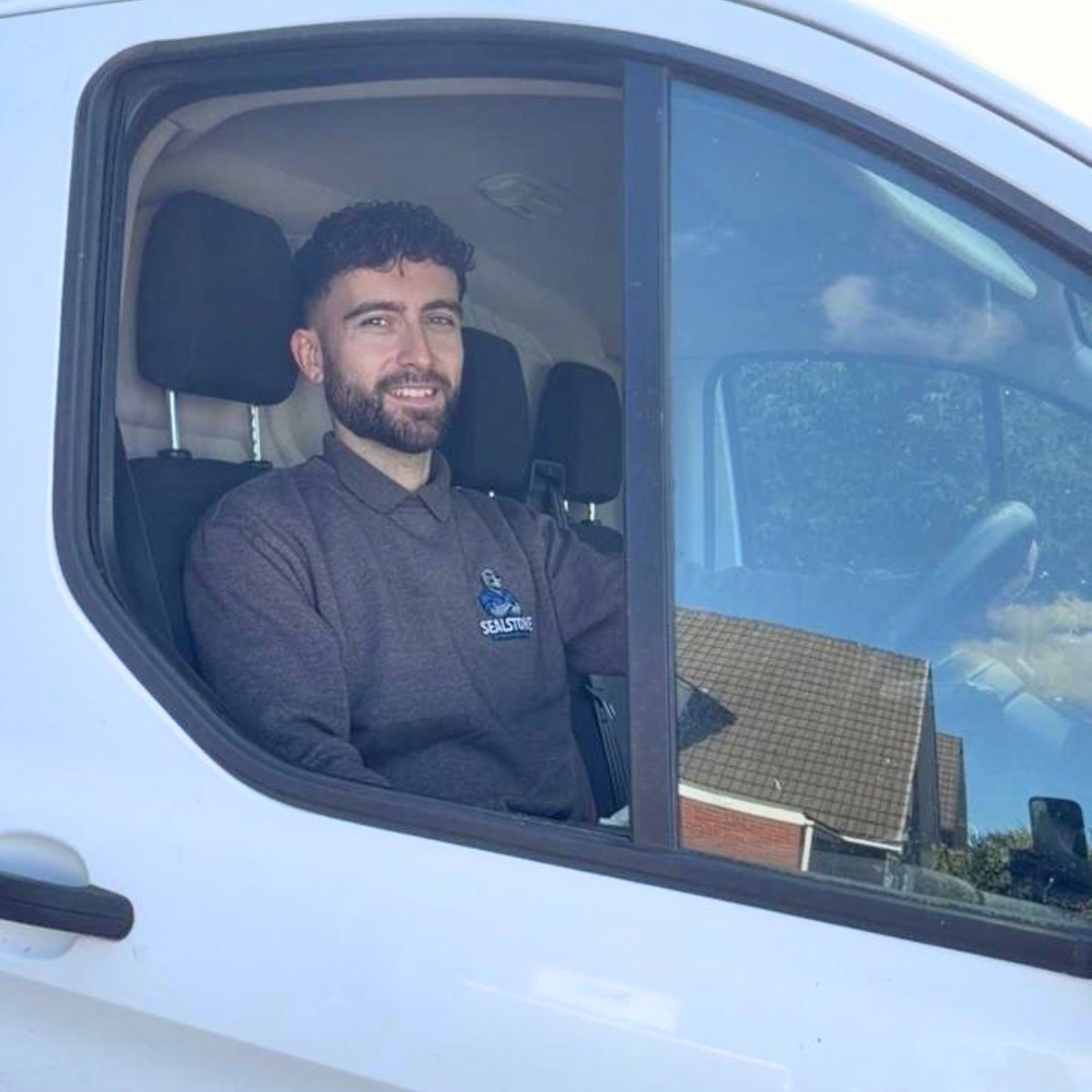 Alex in the Sealstone Exterior Services van